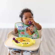 Load image into Gallery viewer, A baby in a high chair eagerly chews purple utensils while eating from a Bumkins Silicone Grip Dish: Toy Story Alien.