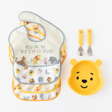 Load image into Gallery viewer, Bumkins Spoon + Fork: Winnie the Pooh lays next to 3 waterproof bibs and a Winnie the Pooh-shaped plate on a white background.