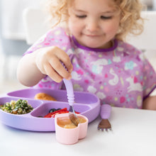 Load image into Gallery viewer, Close-up of a curly-haired girl eating applesauce from a pink heart-shaped cup with a Bumkins Spoon + Fork: Lavender at a white table.
