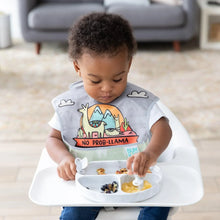 Load image into Gallery viewer, A toddler wearing a llama bib enjoys fruit and snacks from a Bumkins Silicone Grip Dish: Marble with utensils while seated in a high chair.