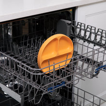 Load image into Gallery viewer, Bumkins Silicone Grip Dish: Tangerine sits in the top rack of an open dishwasher.