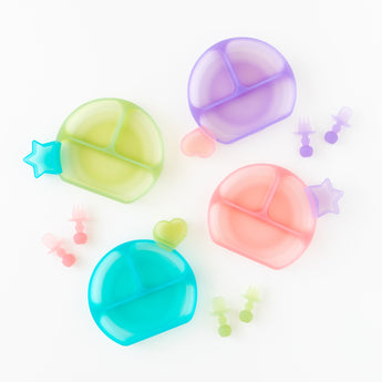 Bumkins Silicone Grip Dish: Blue Jelly sits among other plates and utensils on a white background.
