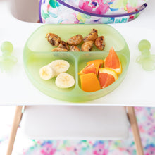 Load image into Gallery viewer, Close-up of a Bumkins Silicone Grip Dish: Green Jelly with bananas, oranges, & pancakes, and green toddler utensils on a high chair tray.