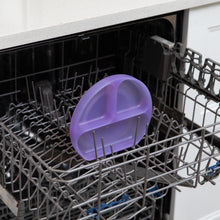 Load image into Gallery viewer, Bumkins Silicone Grip Dish: Purple Jelly sits in the top rack of an open dishwasher.