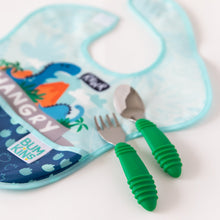 Load image into Gallery viewer, Close-up of Bumkins Spoon + Fork: Jade resting atop a blue dinosaur patterned bib on a white background.