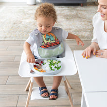 Load image into Gallery viewer, A boy wearing a llama bib in a high chair eats rice & peas from a Bumkins Silicone Grip Plate: Marble as a smiling woman looks on.