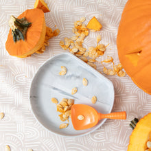 Load image into Gallery viewer, Bumkins Silicone Grip Plate: Marble sits among pumpkin pieces and seeds on a beige patterned mat with an orange scoop.