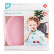 Load image into Gallery viewer, Bumkins Silicone Grip Plate: Pink in a white packaging box with a photo of a child and a clear window partially displaying the dish.