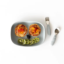 Load image into Gallery viewer, Bumkins Silicone Grip Tray: Gray holds two mini pizzas, garnished with kiwi slices and a blackberry on a white background next to utensils.