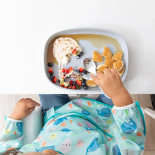 Load image into Gallery viewer, Top-down view of a child enjoying pancakes with fruit and yogurt on a Bumkins Silicone Grip Tray: Gray, wearing a sea creature bib.