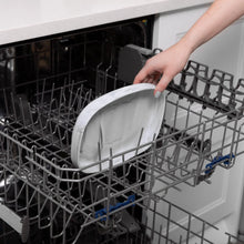 Load image into Gallery viewer, A hand places a Bumkins Silicone Grip Tray: Marble into the top rack of an open dishwasher.