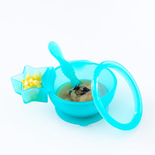 Load image into Gallery viewer, A blue bowl with applesauce and a Bumkins Silicone Little Dipper Combo 2 Pack: Aqua Jelly with fruit are displayed on a white background.