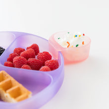 Load image into Gallery viewer, A Bumkins Silicone Little Dipper Combo 2 Pack: Magenta Jelly with whipped cream next to a plate of berries and waffles on a white background.