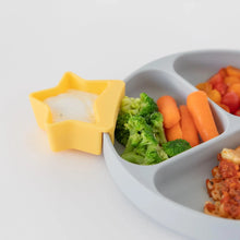 Load image into Gallery viewer, Close-up of a gray plate with veggies and a yellow Bumkins Silicone Little Dipper 3-Pack: Tutti-Frutti with dip on a white background.