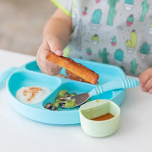 Load image into Gallery viewer, A child dips French toast into syrup in a green Bumkins Silicone Little Dipper Round 3-Pack: Gumdrop attached to a blue plate with food.