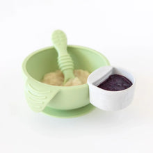 Load image into Gallery viewer, A marble Bumkins Silicone Little Dipper Round 3-Pack: Taffy filled with sauce attached to a green bowl on a white background.