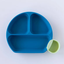 Load image into Gallery viewer, A dark blue plate with a green Bumkins Silicone Little Dipper Round 3-Pack: Taffy on a white background.