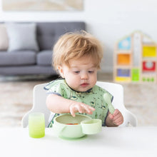 Load image into Gallery viewer, A curly-haired toddler holds a spoon near a green bowl with a green Bumkins Silicone Little Dipper Round 3-Pack: Taffy attached.