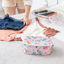 Load image into Gallery viewer, A person uses Bumkins Packing Cube 2 Pack: Boots to neatly organize clothes on a bed.