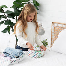 Load image into Gallery viewer, A girl in a white sweater packs clothes into Bumkins Packing Cube 2 Pack: Mickey & Friends Varsity on a bed.
