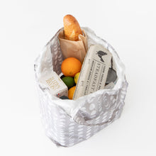 Load image into Gallery viewer, A Bumkins Packable Tote Bag: Lunar Phase holds a baguette, eggs, cans, an orange, and a lime on a white backdrop.