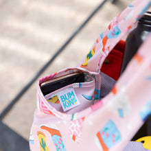 Load image into Gallery viewer, Close-up of Bumkins Packable Tote Bag: Boots with a smartphone in its pocket. Shadows play on the background.