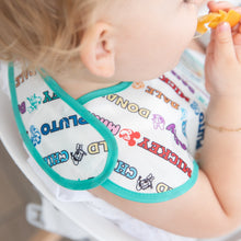 Load image into Gallery viewer, A toddler enjoys an orange slice wearing a colorful Bumkins SuperBib® 3 Pack: Mickey & Friends MVP.
