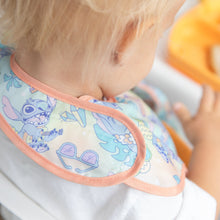 Load image into Gallery viewer, A toddler in a Bumkins SuperBib® 3 Pack: Stitch Star-ring Up Trouble looks down as they sit near an orange tray.