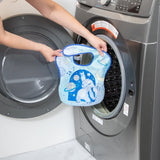 A person holds a Bumkins SuperBib® 3 Pack: Stitch Star-ring Up Trouble in front of an open washing machine.