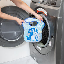 Load image into Gallery viewer, A person holds a Bumkins SuperBib® 3 Pack: Stitch Star-ring Up Trouble in front of an open washing machine.