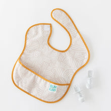 Load image into Gallery viewer, Bumkins Silicone Chewtensils®: Marble rest next to a beige patterned bib on a white background.