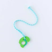 Load image into Gallery viewer, A Bumkins Silicone Accessory Tether 2-Pack: Blue attached to a dinosaur-shaped teether on a white background.