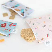 Load image into Gallery viewer, Close-up of Bumkins Reusable Snack Bag, 3-Pack: Princess Magic, Ariel, and Jasmine with food spilling onto a white background.