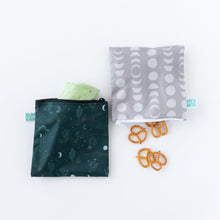 Load image into Gallery viewer, Bumkins Reusable Snack Bag, Large 2 Pack: Desert Night lays on a white background; one with a tortilla wrap, the other with pretzels.