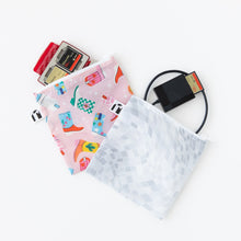 Load image into Gallery viewer, Roamio by Bumkins Reusable Snack Bag, Large 2 Pack: Disco Boots lays overlapped on a white background with electronics like SD cards peeking out.