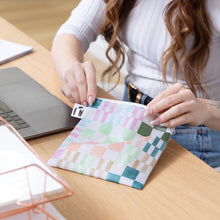 Load image into Gallery viewer, A person opens a Roamio by Bumkins Reusable Snack Bag, Large 2 Pack: Motley Club at a desk next to a laptop and papers.