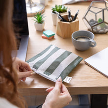 Load image into Gallery viewer, A person unzips a Roamio by Bumkins Reusable Snack Bag, Large 2 Pack: Motley Club at a desk with coffee, a laptop, office supplies, and plants.