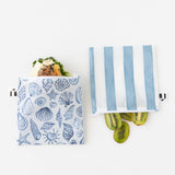 Roamio by Bumkins Reusable Snack Bag, Large 2 Pack: Coastal holds a sandwich and kiwi halves on a white background.