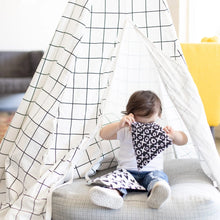 Load image into Gallery viewer, A child in a checkered play tent looks inside a Bumkins Reusable Snack Bag, Large 2-Pack: XOXO & Hearts.