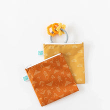 Load image into Gallery viewer, Bumkins Reusable Snack Bag, Large 2-Pack: Sunshine and Grounded lays overlapped on a white background, with an orange teething toy nearby.
