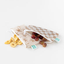 Load image into Gallery viewer, Bumkins Reusable Snack Bag, Small 2 Pack: Palm Check lays on a white background, filled with grapes and banana chips.