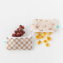Load image into Gallery viewer, Bumkins Reusable Snack Bag, Small 2 Pack: Palm Check holds grapes and banana chips on a white background.