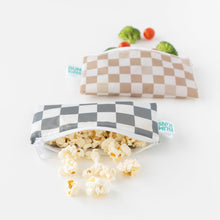Load image into Gallery viewer, Bumkins Reusable Snack Bag, Small 2 Pack: Double Check overflows with popcorn, broccoli, and cherry tomatoes on a white background.