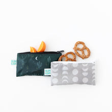 Load image into Gallery viewer, Bumkins Reusable Snack Bag, Small 2 Pack: Desert Night sits on a white background with oranges and pretzels peeking from the tops of the bags.