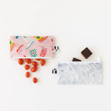 Load image into Gallery viewer, Grape tomatoes and chocolate squares spill from Roamio by Bumkins Reusable Snack Bag, Small 2 Pack: Disco Boots on a white background.