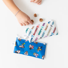 Load image into Gallery viewer, A child's hand reaches for treats near Bumkins Reusable Snack Bag, Small 2 Pack: Mickey & Friends MVP on a white table.