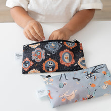Load image into Gallery viewer, A child reaches into a Bumkins Reusable Snack Bag, Small 2 Pack: Everyday Is Halloween on a white table with another bag nearby.
