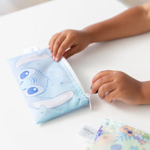 Load image into Gallery viewer, A child opens a Bumkins Reusable Snack Bag, Small 2 Pack: Stitch Star-ring Up Trouble on a white table.