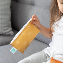 Load image into Gallery viewer, A child on a grey couch holds a yellow Bumkins Reusable Snack Bag, Small 2-Pack: Sunshine and Grounded.