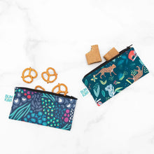 Load image into Gallery viewer, Bumkins Reusable Snack Bag, Small 2-Pack: Jungle & Animal Prints, filled with pretzels and cookies, rests on a marble background.
